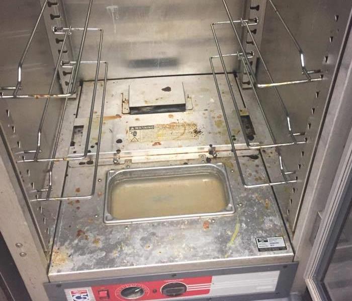 Dirty Oven with caked on burnt food at bottom