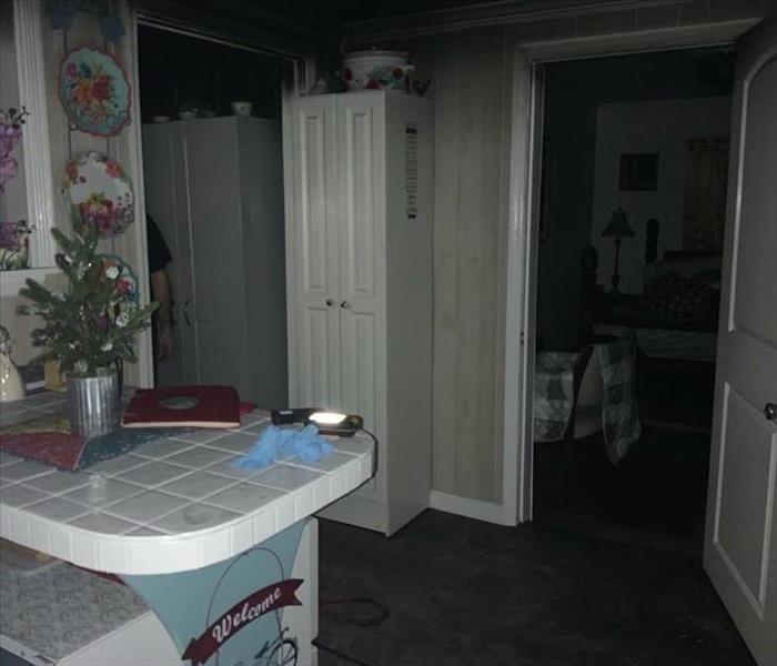A kitchen that has fire damage is shown