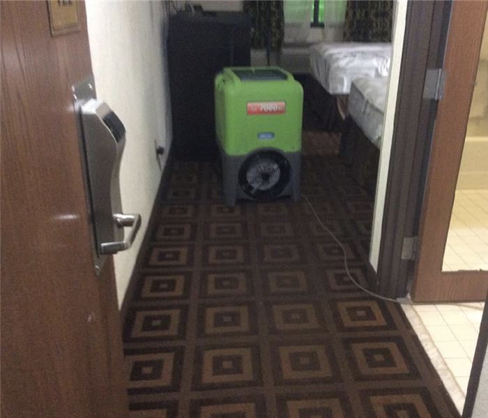 A hotel room that has been dried after water damage is shown