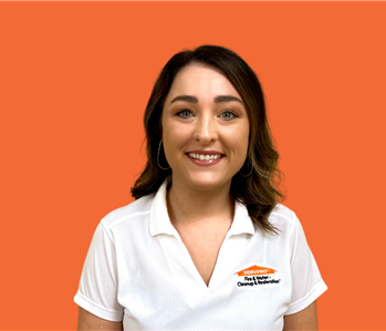New Employee - Ericca B smiling on an orange background