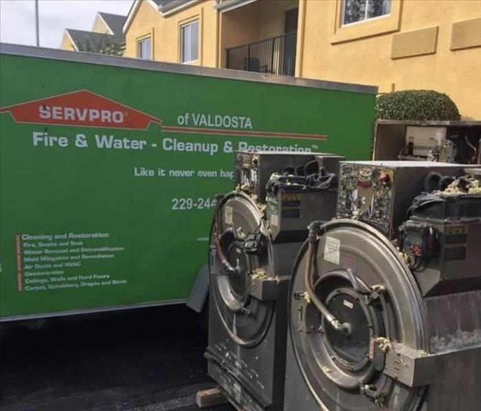 A Green SERVPRO truck and additional equipment is shown on the job