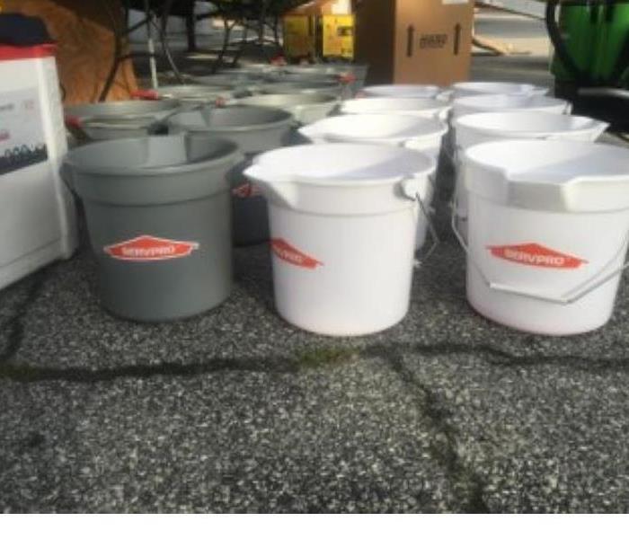 Gray and white SERVPRO buckets are shown