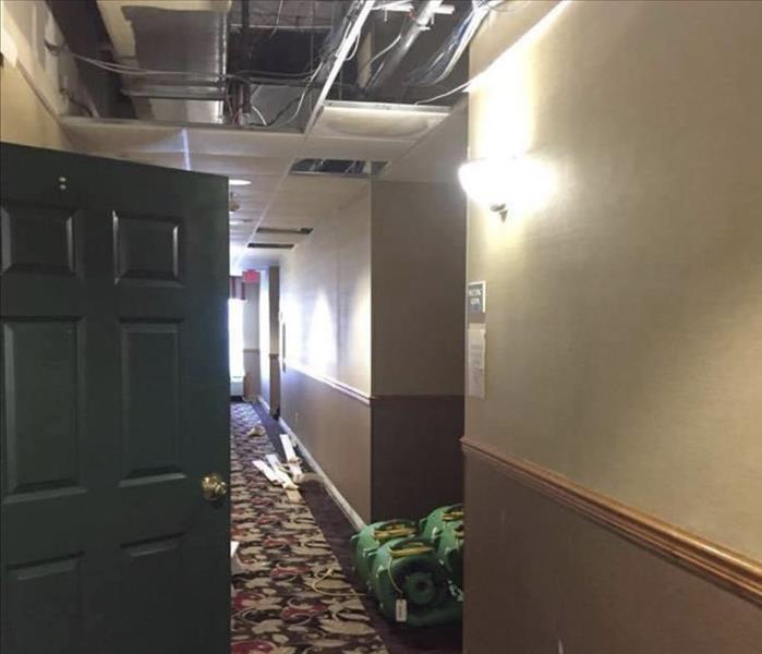 The hallway of a storm damaged hotel is shown 