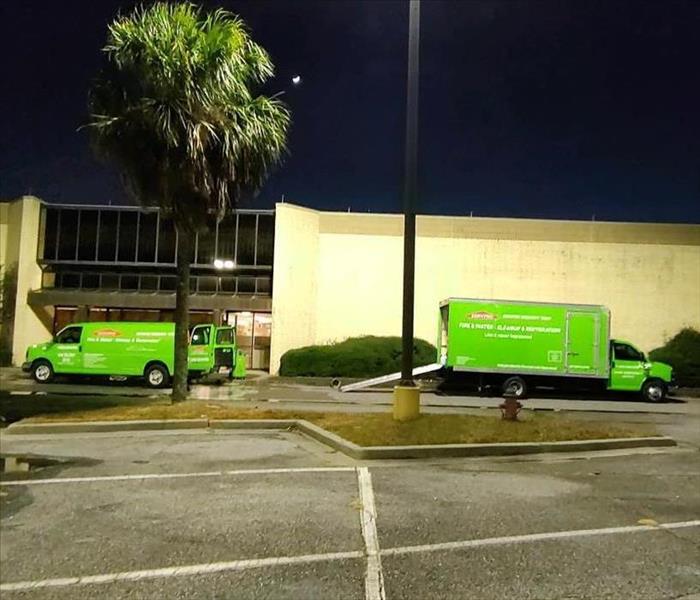 green SERVPRO trucks outside of commercial property